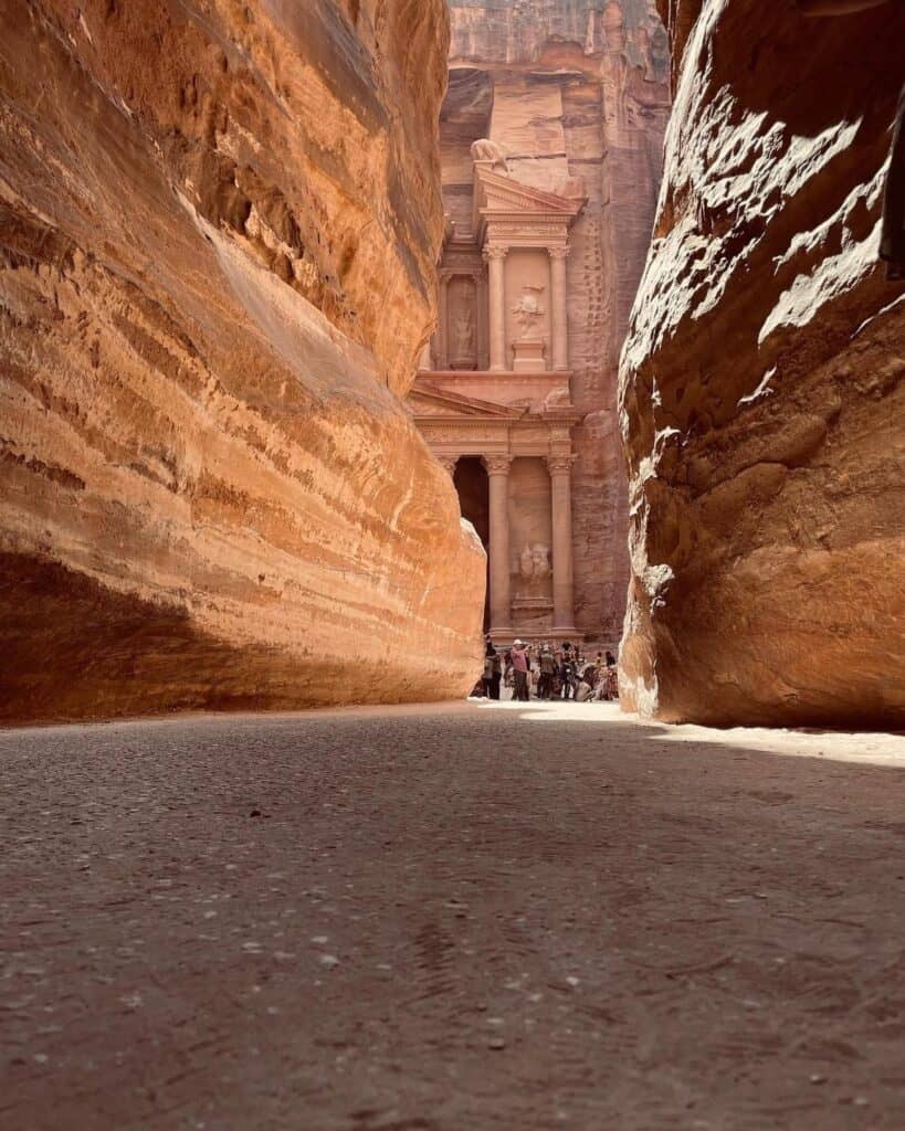 The iconic Petra Treasury (Al-Khazneh) glowing in golden morning light, a key highlight of a Petra Day Tour from Amman.