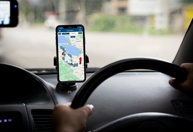 Person navigating a self-drive tour in Jordan using GPS on a smartphone, showing a mapped route between tourist destinations.